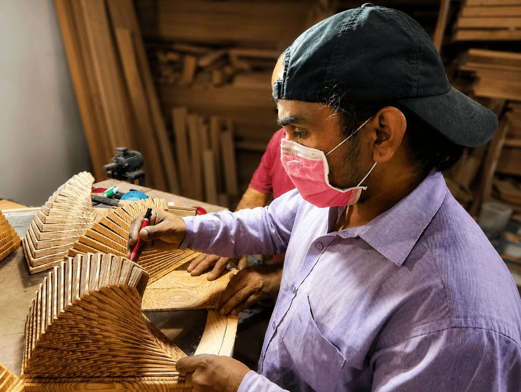 FOR ARTISAN IMPACT - artisan handcrafting a premium wooden pendant lamp